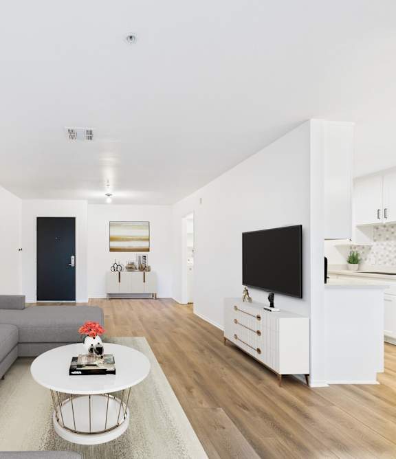 A room with wooden flooring and a window with blinds.
