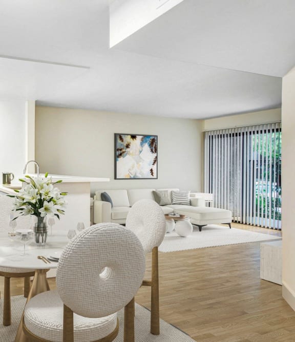 a living room and dining room with a table and chairs