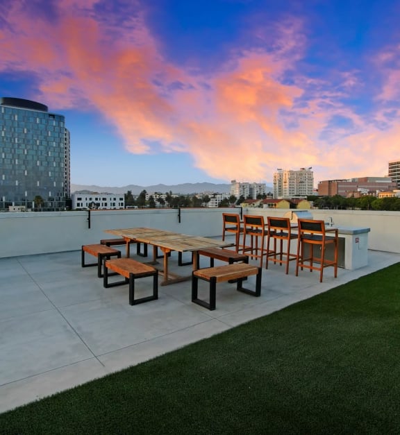 a balcony with a table and chairs and a view of the city