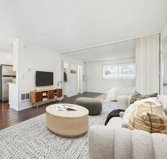 A living room with a wooden floor and furniture.