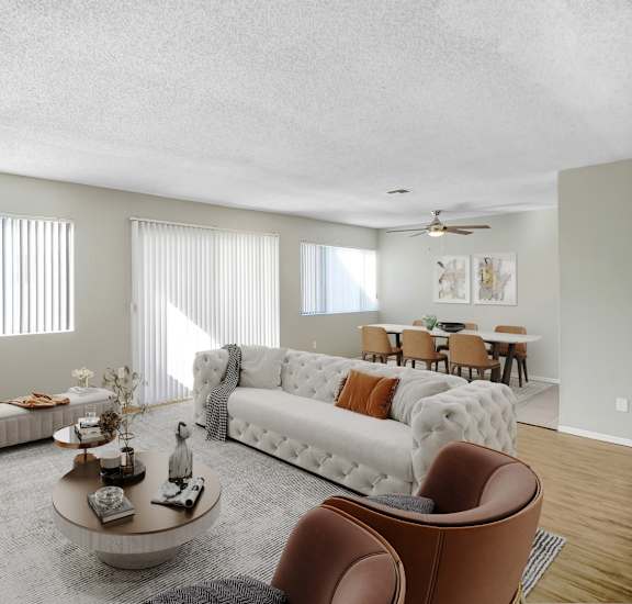 A living room with a white couch, a grey rug, and a coffee table.