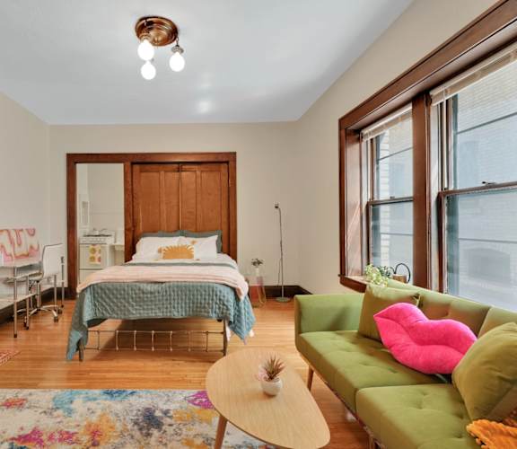 a bedroom with a bed and a couch