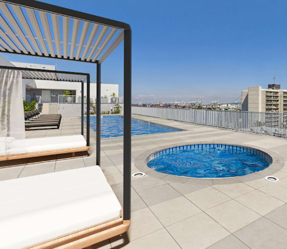 A pool on a balcony with a chair and a table.