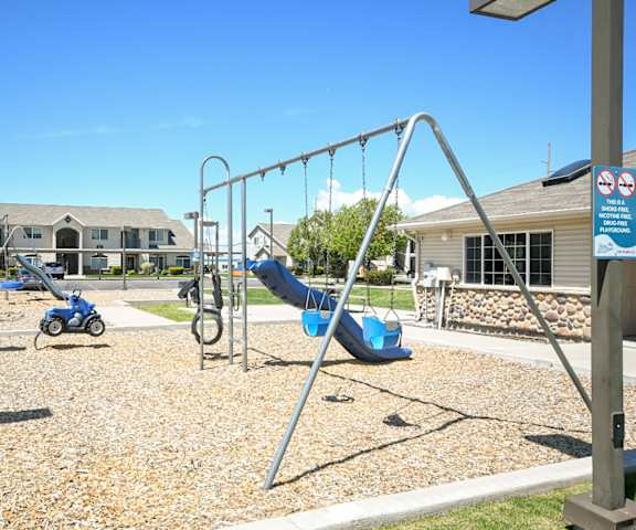 a childrens playground with a chain link fence with the word play in the foreground