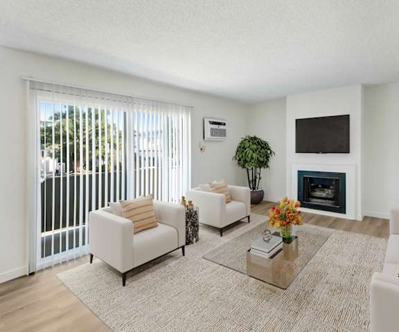 A living room with a fireplace and a television.