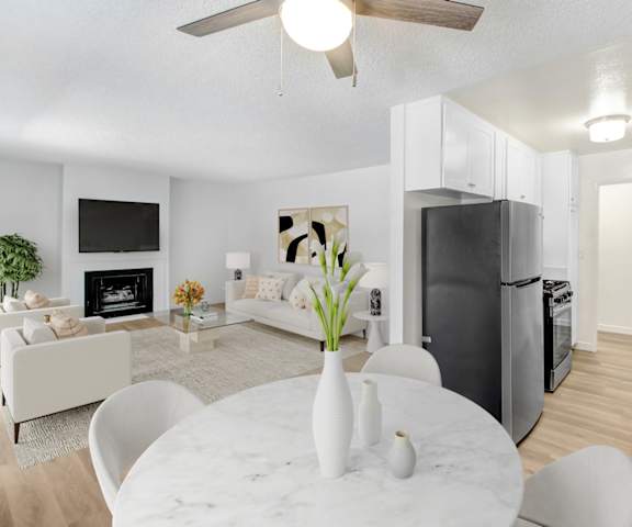 A modern kitchen with a white table and chairs.