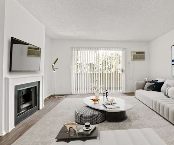 a living room with a white couch and a fireplace