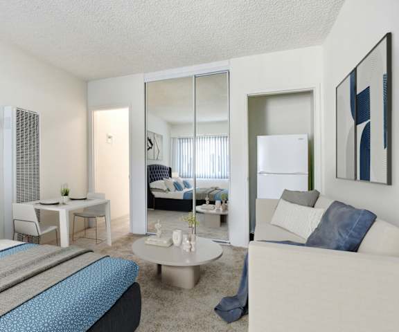 a bedroom with a bed and a desk and a mirror