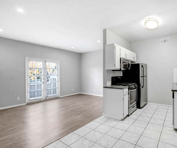 a kitchen with a stove and a refrigerator and a sink