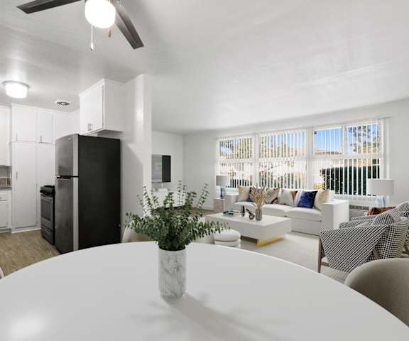 a living room and dining room with a white table
