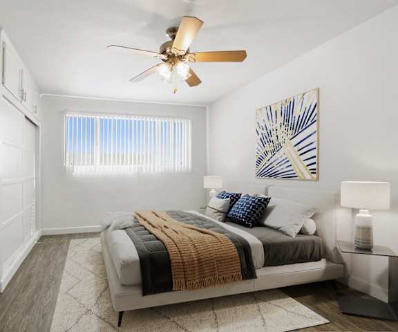 a bedroom with a bed and a ceiling fan