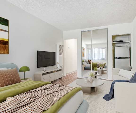 a living room with a couch and a bed and a tv
