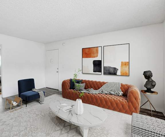 a living room with a orange couch and a white table