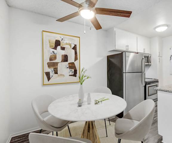 a kitchen and dining room with a white table and chairs