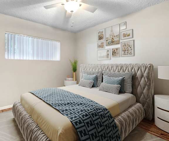 a bedroom with a bed and a ceiling fan