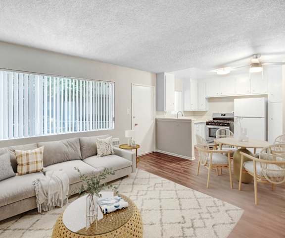 an open living room and kitchen with a couch and a table