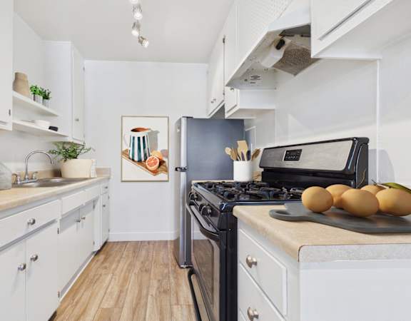 A kitchen with a black stove top oven and a black fridge.