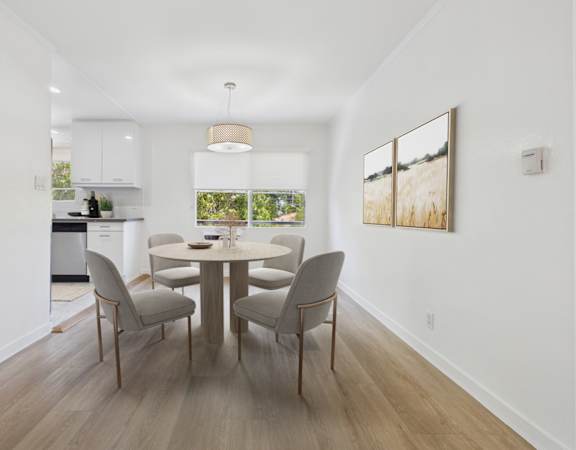 A dining room with a table and chairs.