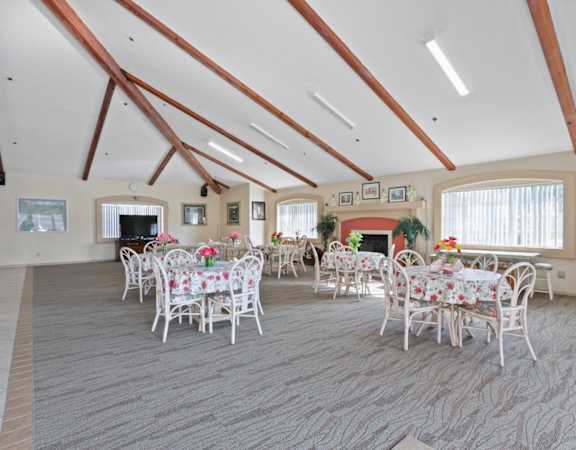 a dining room with tables and chairs and a fireplace