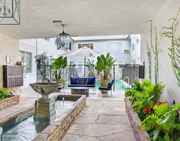 a living room with a fountain and a pool