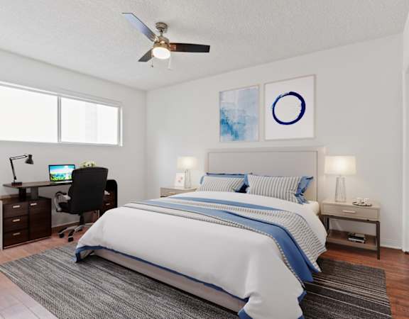a bedroom with a large bed and a ceiling fan