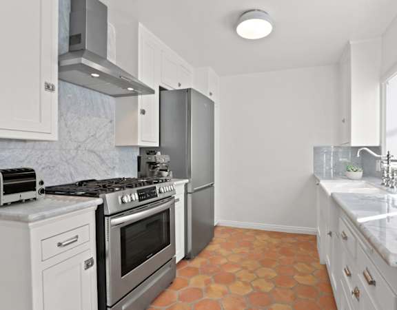 a kitchen with stainless steel appliances and white cabinets