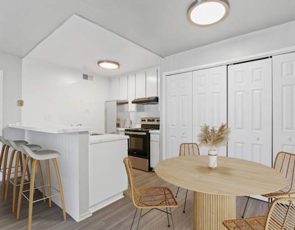 a dining room and kitchen with a table and chairs