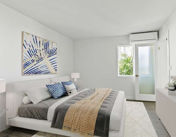 a bedroom with a bed and a door to a bathroom