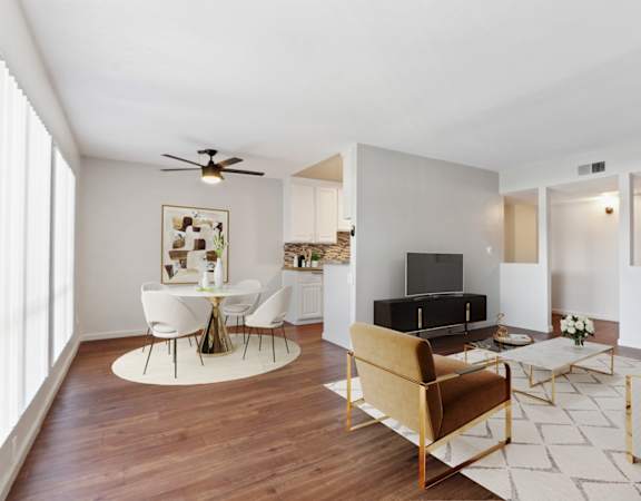 a living room with furniture and a ceiling fan