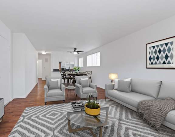 a living room with a couch and chairs and a coffee table
