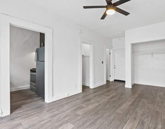 a living room with hardwood floors and white walls