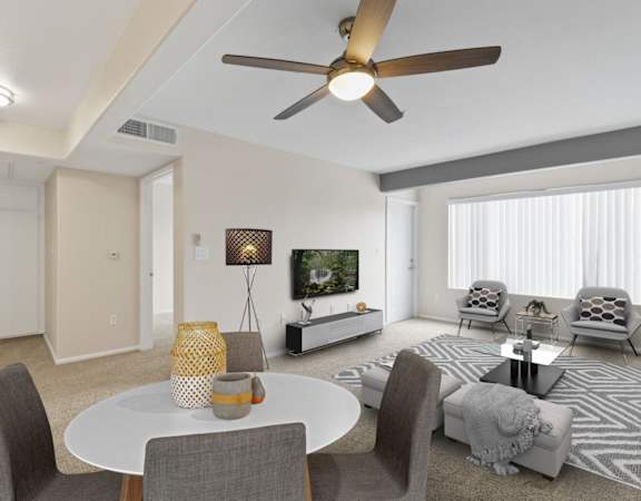 a living room with a white table and chairs and a ceiling fan