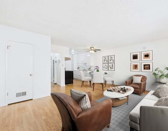 A living room with a brown leather chair and a grey couch.