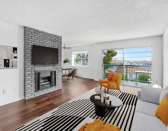 a living room with a fireplace and a striped rug