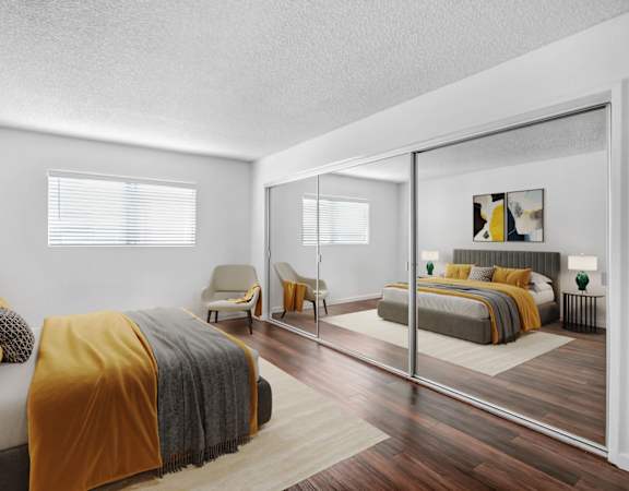 a bedroom with two beds and a large mirror