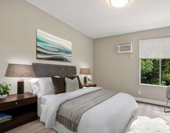 a bedroom with a bed and a chair in a room