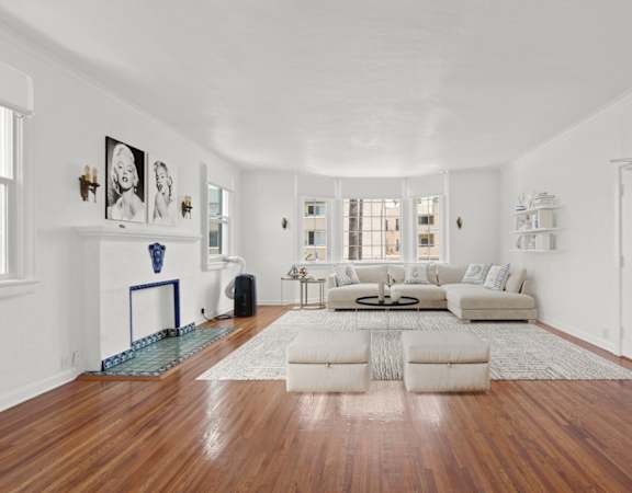 a living room with a white couch and a fireplace