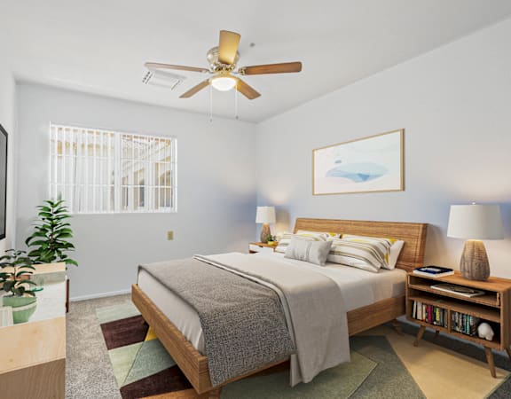 a bedroom with a large bed and a ceiling fan