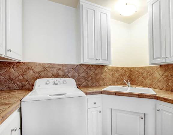 a white kitchen with white appliances and white cabinets