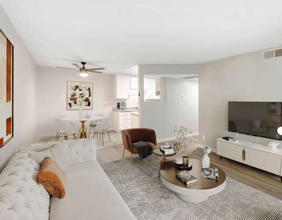a living room with a white couch and a tv
