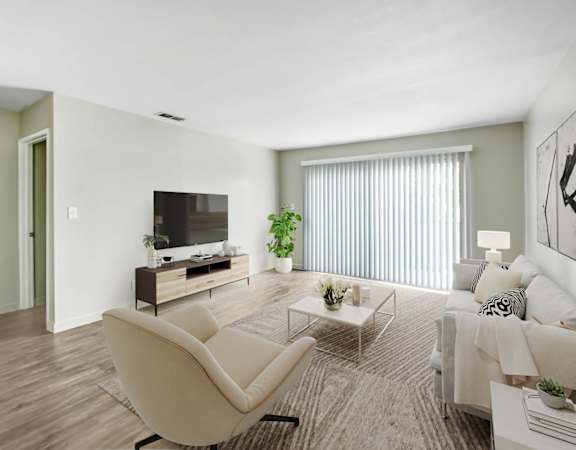 a living room with a couch and a chair and a television