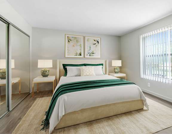 a bedroom with a bed and a window