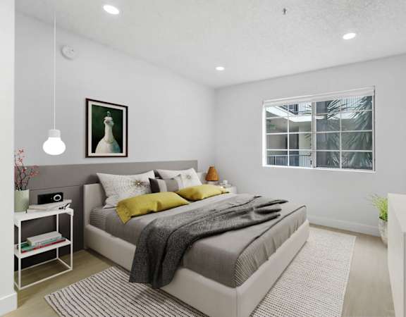 a bedroom with a bed and a window