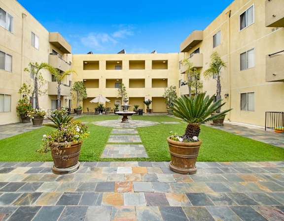 a courtyard with a fountain in the middle of an apartment building