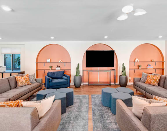 a living room with couches and chairs and a television