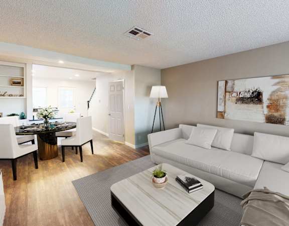 A modern living room with a white couch and a coffee table.