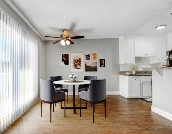 A dining room with a table and chairs.