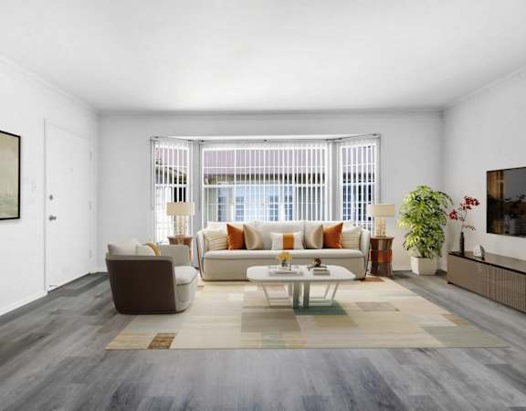 A living room with a brown and white sofa set, a coffee table, and a large painting on the wall.