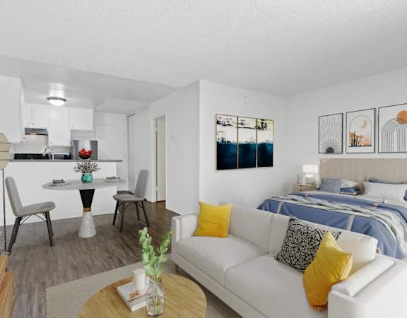 a living room with a couch and a table and a bed