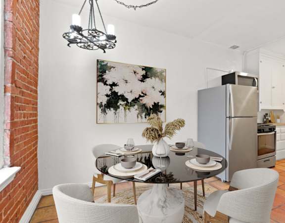 a dining room with a table and chairs and a refrigerator